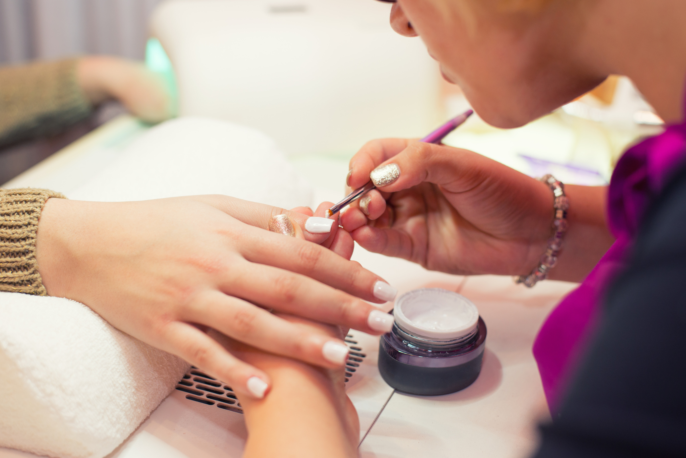 Manicurist making artificial nails in the nail salon